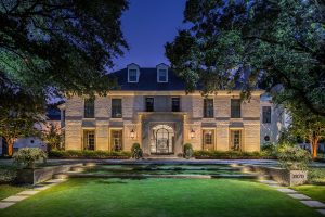 house at night with landscape lights along the front facade