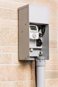 low voltage transformer mounted on wall with a timer